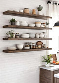 Wooden shelves with kitchen items against a white tiled wall